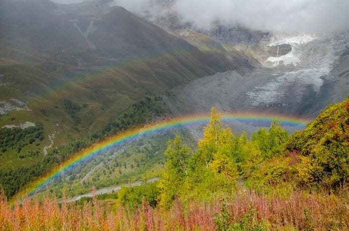 Glacier with a rainbow in the foreground on the trek to Ushguli, Svaneti, northern Georgia.